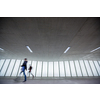 Motion blurred people - figures in an underpassage getting to their workplace in the morning. Busy city business life.