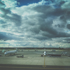 Airport view with aircraft in the parking lot, airplane landing, plane flying in the sky. Air logistic, planes at airport. Travel and transportation concept. Empty place for text, copy space.