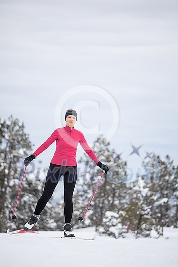 Cross-country skiing: young woman cross-country skiing on a winter day Cross-country skiing: young woman cross-country skiing on a winter day