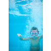 Cute little boy in a swimming pool, diving, swimming underwater, having fun