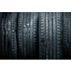 Stack of brand new high performance car tires on clean high-key white studio background