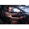 Underground parking/garage (shallow DOF; color toned image) - young woman driving her car in the underground parking
