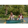Couple adventurous explorer friends are canoeing in a wild river surrounded by the beautiful nature