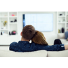 Relaxed young couple watching tv at home in bright living room
