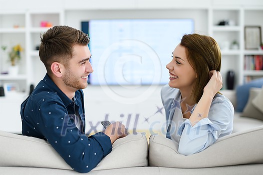 a young married couple enjoys sitting in the large living room, a young couple spending their time together
a young married couple enjoys sitting in the large living room, a young couple spending their time together