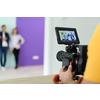 a cameraman with professional equipment shoots video clips in the studio
