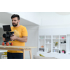 a cameraman with professional equipment shoots video clips in the studio
