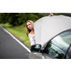 Pretty middle aged woman having car troubles - broken down car on the side of the road, calling the insurance company for assistance