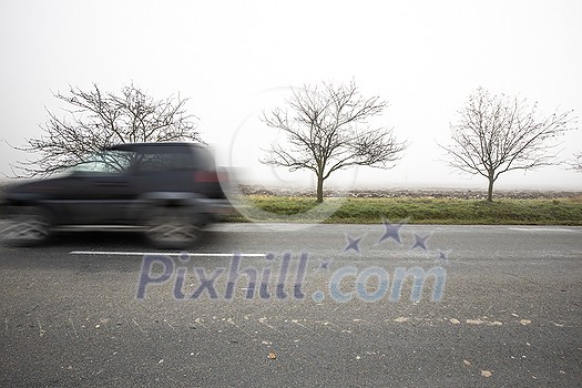 Motion blurred truck going fast on a rural road Motion blurred truck going fast on a rural road