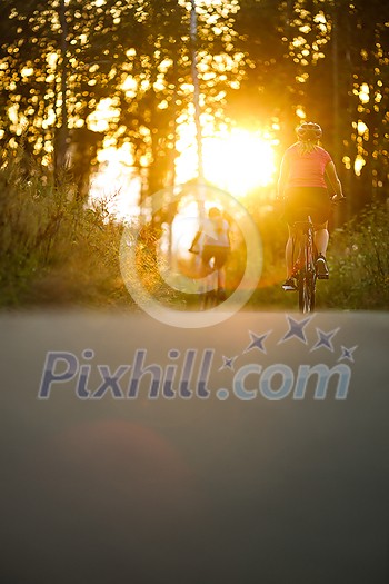 Happy couple riding bicycles outside, healthy lifestyle fun concept, taking a break admiring the view Happy couple riding bicycles outside, healthy lifestyle fun concept, taking a break admiring the view