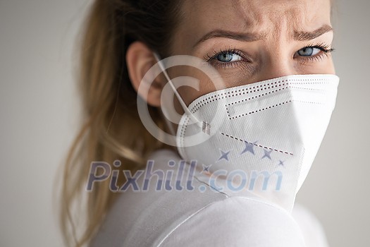 Young woman wearing a face mask during coronavirus and flu outbreak. Virus and illness protection, home quarantine. COVID-19 concept Young woman wearing a face mask during coronavirus and flu outbreak. Virus and illness protection, home quarantine. COVID-19 concept