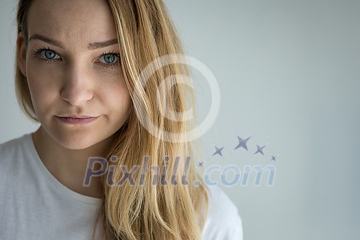 Pretty, young woman looking at the camera - pensive, pondering Pretty, young woman looking at the camera - pensive, pondering