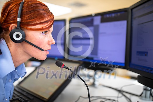 Call centre employee communicating over phone using an external microphone for better sounf and ergonomics Call centre employee communicating over phone using an external microphone for better sounf and ergonomics