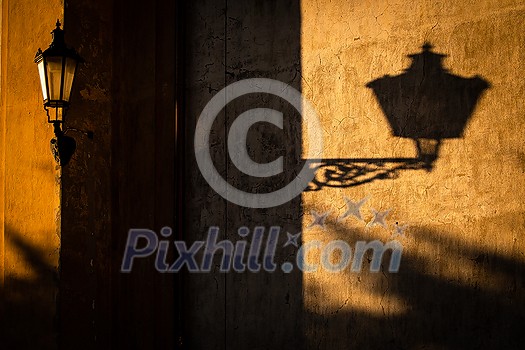 Old lantern in warm evening light in an old downtown street Old lantern in warm evening light in an old downtown street