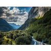 Aerial top view of summer green trees in forest with a splendid mountain river in Swiss Alps