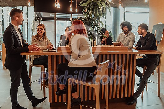 Group of friends hanging out in a coffee shop with a laptop amongst them. Happy young people sitting at restaurants using a laptop Group of friends hanging out in a coffee shop with a laptop amongst them. Happy young people sitting at restaurants using a laptop