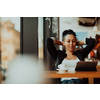 a businesswoman sitting in a cafe on a break and using a tablet 