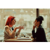 One-on-one meeting.Two young business women sitting at table in cafe.Girl using laptop, smartphone, blogging. Teamwork, business meeting. Freelancers working.