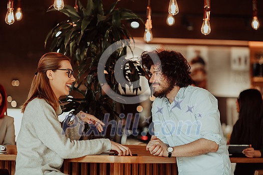 a woman in glasses and men with afro hair sit in a cafe and talk about business projects a woman in glasses and men with afro hair sit in a cafe and talk about business projects