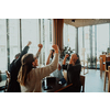 group of businessmen with their hands up celebrate successful business