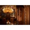 Splendid chandelier with lit candles in a beautiful room of an old mansion