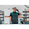 Heavy Industry Engineering Factory Interior with Industrial Worker Using Angle Grinder and Cutting a Metal Tube. Contractor in Safety Uniform and Hard Hat Manufacturing Metal Structures. High quality photo
