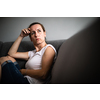Depressed mid-aged woman at home feeling sad, lonely, anxious (color toned image)