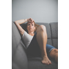 Depressed mid-aged woman at home feeling sad, lonely, anxious (color toned image)