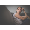 Depressed mid-aged woman at home feeling sad, lonely, anxious (color toned image)