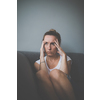Depressed mid-aged woman at home feeling sad, lonely, anxious (color toned image)
