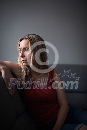 Depressed mid-aged woman at home feeling sad, lonely, anxious (color toned image) Depressed mid-aged woman at home feeling sad, lonely, anxious (color toned image)