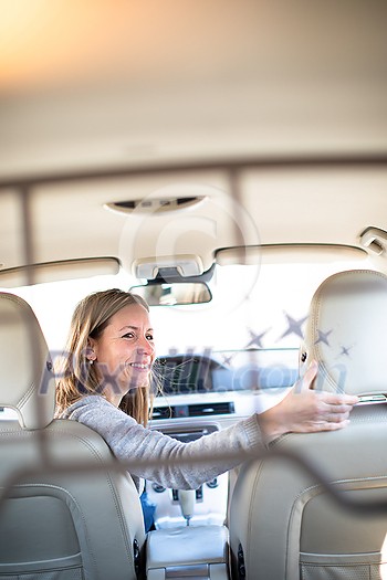 Pretty, young woman driving a car -Invitation to travel. Car rental or vacation. Pretty, young woman driving a car -Invitation to travel. Car rental or vacation.