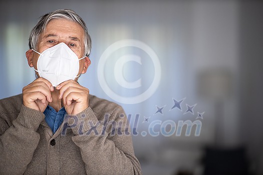 Senior man wearing a facemask during coronavirus and flu outbreak. Virus and illness protection, home quarantine. COVID-19 concept Senior man wearing a facemask during coronavirus and flu outbreak. Virus and illness protection, home quarantine. COVID-19 concept