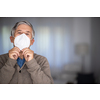 Senior man wearing  a facemask during coronavirus and flu outbreak. Virus and illness protection, home quarantine. COVID-19 concept