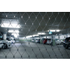 Underground parking. Cars parked in a garage with no people. Many cars in parking garage interior. Underground parking with cars (color toned image)