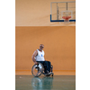 a war invalid in a wheelchair train with a ball at a basketball club in training with professional sports equipment for the disabled. the concept of sport for people with disabilities. High quality photo