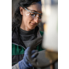 Woman worker wearing safety goggles control lathe machines to drill components. Metal lathe industrial manufacturing factory. High quality photo