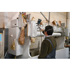 A worker painting to mechanical part with airless spray. High quality photo