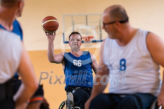handicapped war veterans in wheelchairs with professional equipment play basketball matches in the hall. the concept of sports with disabilities. High quality photo handicapped war veterans in wheelchairs with professional equipment play basketball matches in the hall. the concept of sports with disabilities. High quality photo