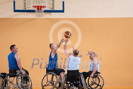 Disabled War veterans mixed race opposing basketball teams in wheelchairs photographed in action while playing an important match in a modern hall. High quality photo Disabled War veterans mixed race opposing basketball teams in wheelchairs photographed in action while playing an important match in a modern hall. High quality photo