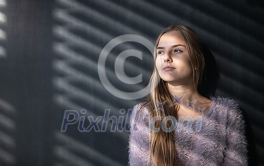 Pretty, young female student in front of a blackboard during class Pretty, young female student in front of a blackboard during class