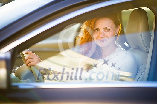 Pretty, young woman driving a car -Invitation to travel. Car rental or vacation. Pretty, young woman driving a car -Invitation to travel. Car rental or vacation.