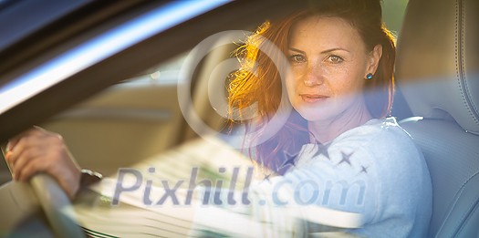 Pretty, young woman driving a car -Invitation to travel. Car rental or vacation. Pretty, young woman driving a car -Invitation to travel. Car rental or vacation.