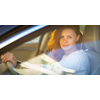 Pretty, young woman  driving a car -Invitation to travel. Car rental or vacation.