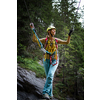 Pretty, female climber on a via ferrata - climbing on a rock in Swiss Alps