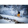 Winter sports - young man walking with snowshoes uphill in high mountains covered with lots of snow