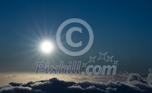 Sky above clouds with sun shining intensely - Earth's atmosphere concept Sky above clouds with sun shining intensely - Earth's atmosphere concept