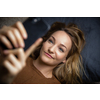 Pretty, young woman using her smart phone at home