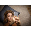 Pretty, young woman using her smart phone at home