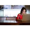 Pretty, mid-aged woman having a virtual Wine Tasting Dinner Event Online Using Laptop with friends